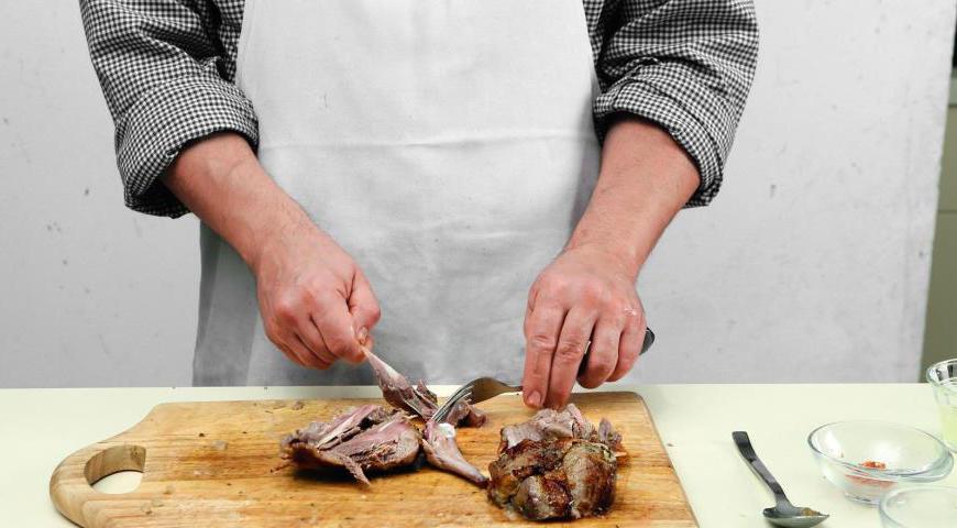 Достаньте индейку из духовки и отделите мясо от костей с помощью вилки. Процедите соус, который образовался на дне кастрюли. Очистите оставшийся лук и чеснок, нарежьте их кубиками и обжарьте на оливковом масле до мягкости. Добавьте индейку, 3 ст. л. лимонного сока, орегано, соль и перец. Тушите 10 минут.