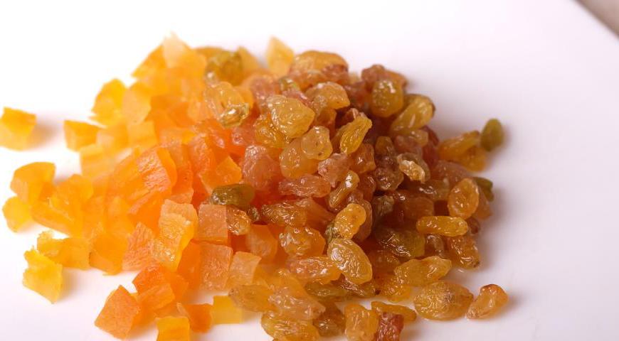 Курагу нарежьте мелкими кубиками. Изюм тщательно промойте под проточной водой и обсушите бумажным полотенцем.
