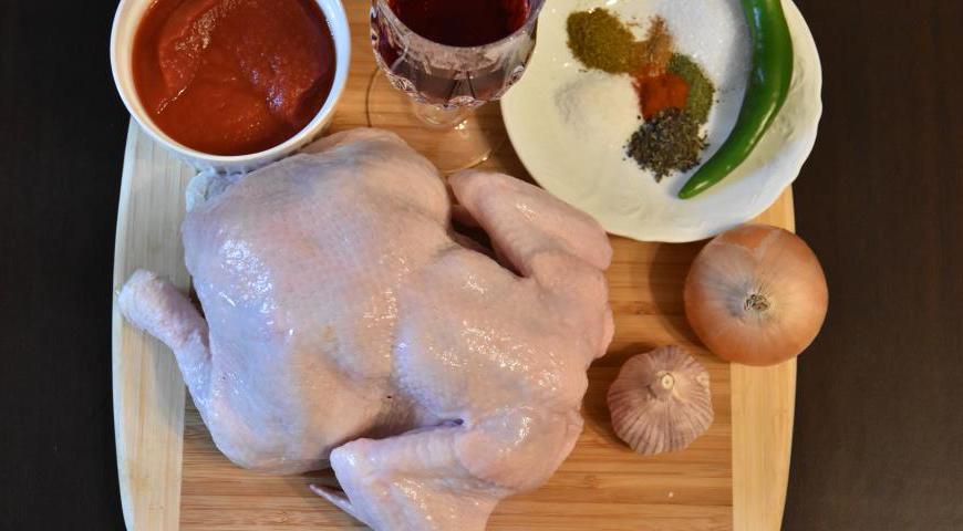 Подготовьте все необходимые продукты: курицу, лук, чеснок, вино, томатный соус, растительное и сливочное масло, соль, сахар и набор специй.