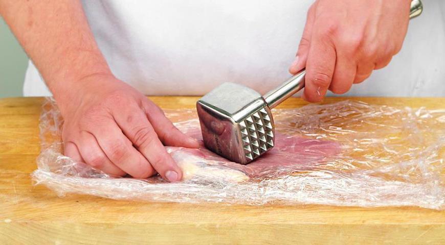 Накройте каждое филе пищевой пленкой и аккуратно отбейте скалкой, чтобы мясо стало немного тоньше. Сделайте один край особенно тонким, чтобы легче было скрутить рулет.