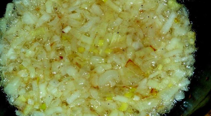 Налейте растительное масло в казан и хорошо разогрейте. Выложите лук и обжаривайте его на среднем огне до красивого золотистого цвета, постоянно помешивая.