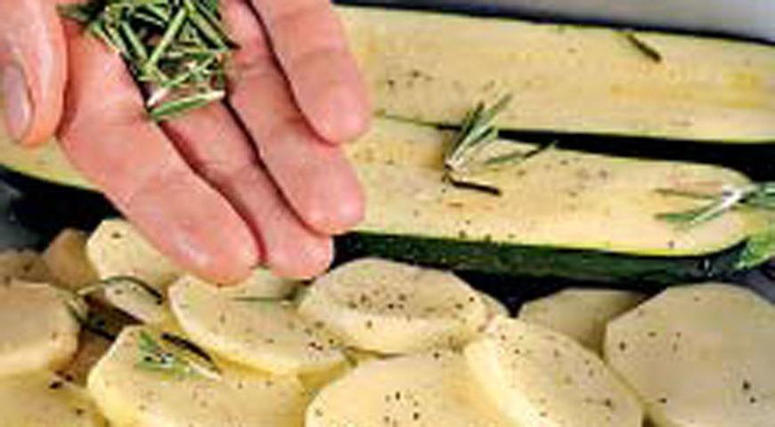 Чеснок нарежьте тонкими пластинами, картофель и цукини – кружками. У шалфея удалите стебли, а затем измельчите листики. Выложите подготовленные овощи на противень с высокими бортиками, присыпьте шалфеем, сбрызните маслом и приправьте солью и перцем. Поставьте в разогретую до 220 °С духовку на 27 минут.