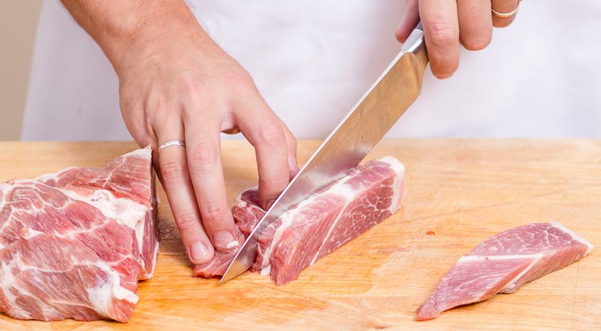 Свиной окорок и копченый шпик нарежьте средними кусками произвольной формы. Два раза пропустите через мясорубку, используя решетку с отверстиями диаметром не менее 7 мм для получения более грубой текстуры.