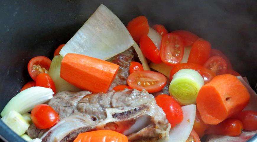 Очистите и нарежьте крупными кусками лук, лук-порей, морковь и помидоры. Если нет больших помидоров, можно взять черри — результат будет не менее вкусным.
