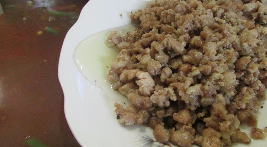 Добавьте обжаренный фарш и нарезанное мясо в суп, хорошо перемешав содержимое кастрюли.