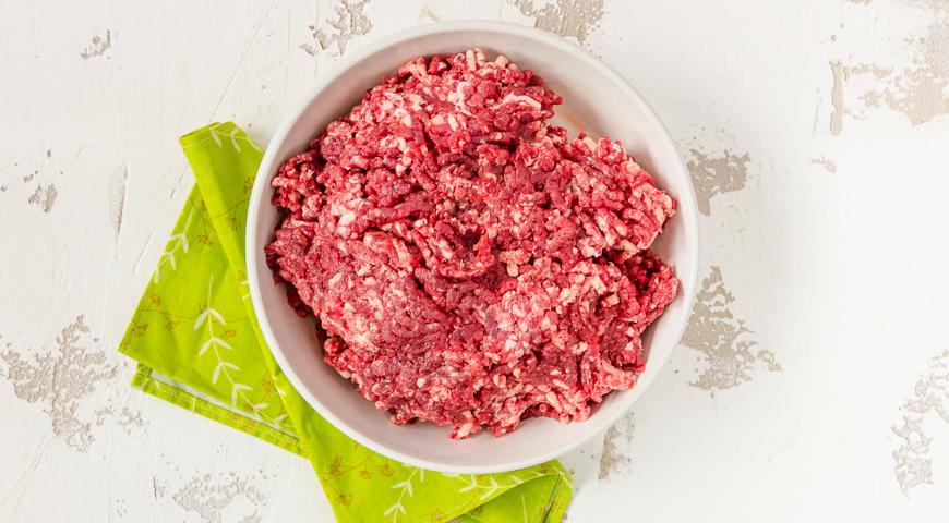 Прокрутите мясо и сало через мясорубку, чтобы получить однородную массу. Очистите лук и мелко порежьте его. В сотейнике разогрейте оливковое масло и тушите лук до мягкости и золотистого цвета, чтобы он стал сладким и ароматным.